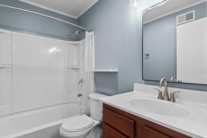 A bathroom with a bathtub, toilet, and sink. - Newly Renovated Unit in Central Spfld! #101 (Springfield)