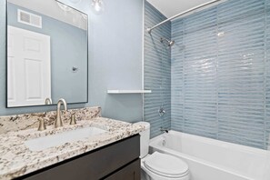 Shower, hair dryer, towels, shampoo