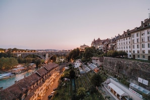 A historic town with a river, a bridge, and traditional buildings.