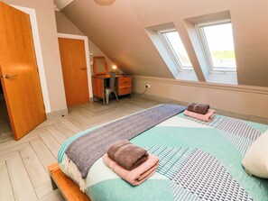 A bedroom with a bed, a desk, a chair, and a window. - Ledrishmore View (Alexandria)