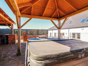 A covered outdoor area with a pool table, a brick wall, and a wooden pergola structure. - Ledrishmore View (Alexandria)