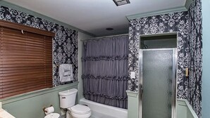 A bathroom with a toilet, sink, bathtub, and shower. - The Rowling at The Manor on  Rosedale Bed & Breakfast  (Highspire)