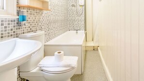 A bathroom with a toilet, sink, and bathtub. - The Anchorage (Whitby)