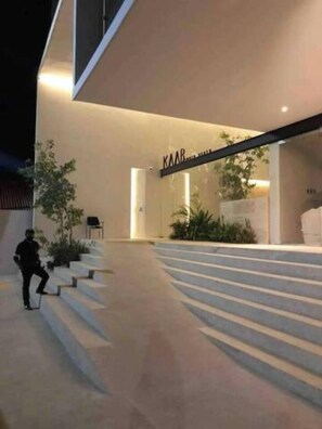 A modern building with a staircase leading to a door labeled 'KAAR'. - Playa del Carmen Studio|Steps away from the Ferry+Rooftop (Playa del Carmen)