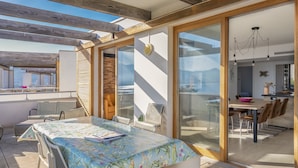 Un interno moderno con zona pranzo, un'ampia finestra e vista sull'esterno.