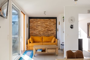 Ein Wohnzimmer mit einer Couch, einem Couchtisch und einer Wanduhr.