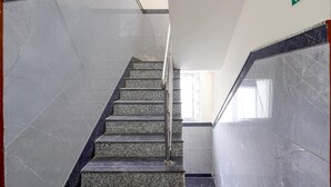 A staircase with marble steps and handrails, leading to an exit. - Classic Airport Stay (Nelamangala)