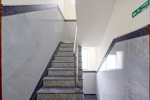 A staircase with marble steps and handrails, leading to an exit. - Classic Airport Stay (Nelamangala)