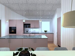 A modern kitchen with a central island, pendant lighting, and a window providing natural light.