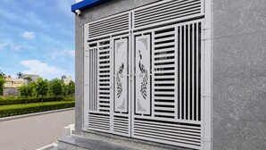 A building facade with a modern design, featuring a series of vertical slats and decorative panels with geometric patterns.