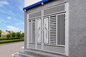 A building facade with a modern design, featuring a series of vertical slats and decorative panels with geometric patterns.