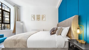 A modern bedroom with a bed, bedside table, and artwork on the wall. - 3 -Berry Street EC1V (London)