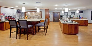 A kitchen with a central island, bar stools, and a stone backsplash. - Spacious 2BR Suite w/ Free Breakfast + Pool (Schertz)
