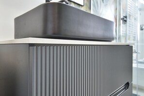 A modern, metallic kitchen with a built-in oven and a stainless steel backsplash. - Newly built room with wifi and large bathroom (Rho)