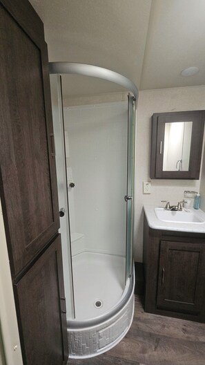 Shower, towels, toilet paper - Wildwood camper #5  at Heaven's Ridge Campground (Fair Play)
