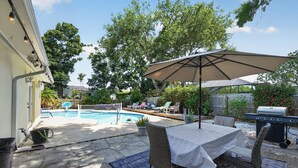A backyard with a pool, outdoor furniture, and a grill. - Coastal Largo Retreat, Pool, Minutes to Indian Rocks Beach, Dog Friendly (Largo)