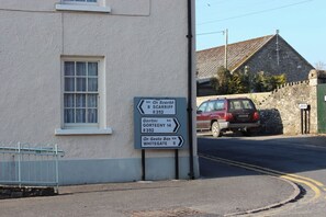 A directional signpost with destinations and distances.