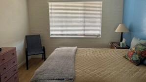 A bedroom with a bed, a chair, a dresser, a window with blinds, a lamp, and a ceiling fan. - Charming apartment unit B ,  in beautiful Green Valley with cool AC breeze (Green Valley)