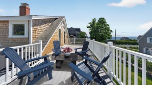 A deck with Adirondack chairs, a table, and a flower vase. - Steps To Peggotty Beach! Slps 10 + Dogs OK! (Scituate)
