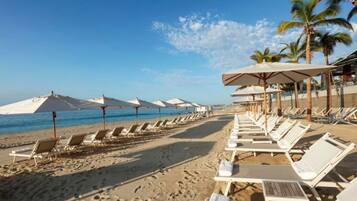 On the beach, sun-loungers, beach towels