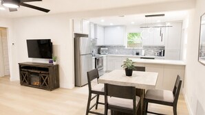 A modern kitchen with white cabinets, a built-in oven, and a large refrigerator. - Modern Dallas Retreat • Golf • Speakeasy• Fire Pit (Dallas)