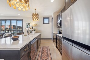 A modern kitchen with a large island, stainless steel appliances, and a decorative pendant light. - Modern 2BR : Historic Lebanon • Sleeps 4 (Lebanon)