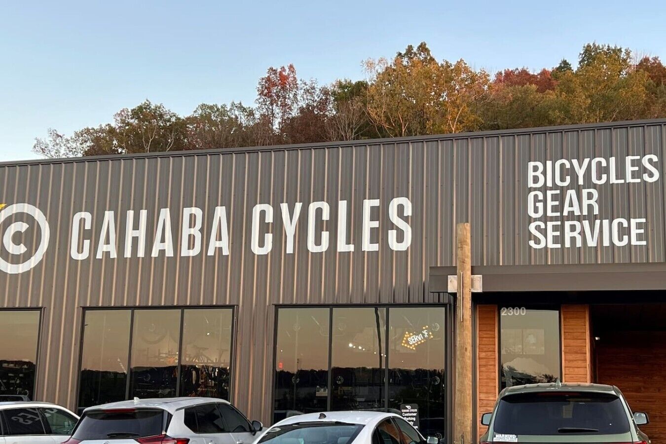 A building with a sign reading 'CAHABA CYCLES' and 'BICYCLES GEAR SERVICE'.