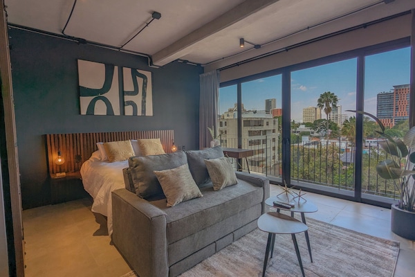 Luxury Studio Suite, City View | Living area | 50-inch Smart TV with digital channels