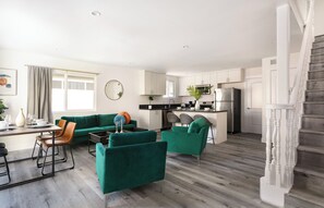 A modern apartment with a dining area, living room, kitchen, and staircase. - Chic City Apt Near Americana Glendale (Glendale)