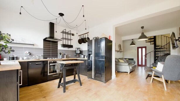 A modern kitchen with a central island, stainless steel appliances, and a dining area with a table and chairs. - super king size bed room with cozy and big bed for 3 in fmaily home (Hornchurch)