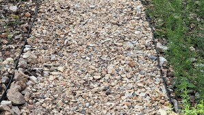 A gravel path in a wooded area with trees and a small building in the background. - 3+bed 3 bath w/2 slip covered dock,on a cove in Duck Creek parking for trailers (Afton)