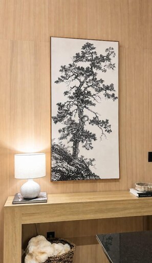 A framed black and white tree painting on a wooden wall, a white lamp, and a small basket. - Private Romantic Escape with Scenic Views + Fire Pit (Sparta)