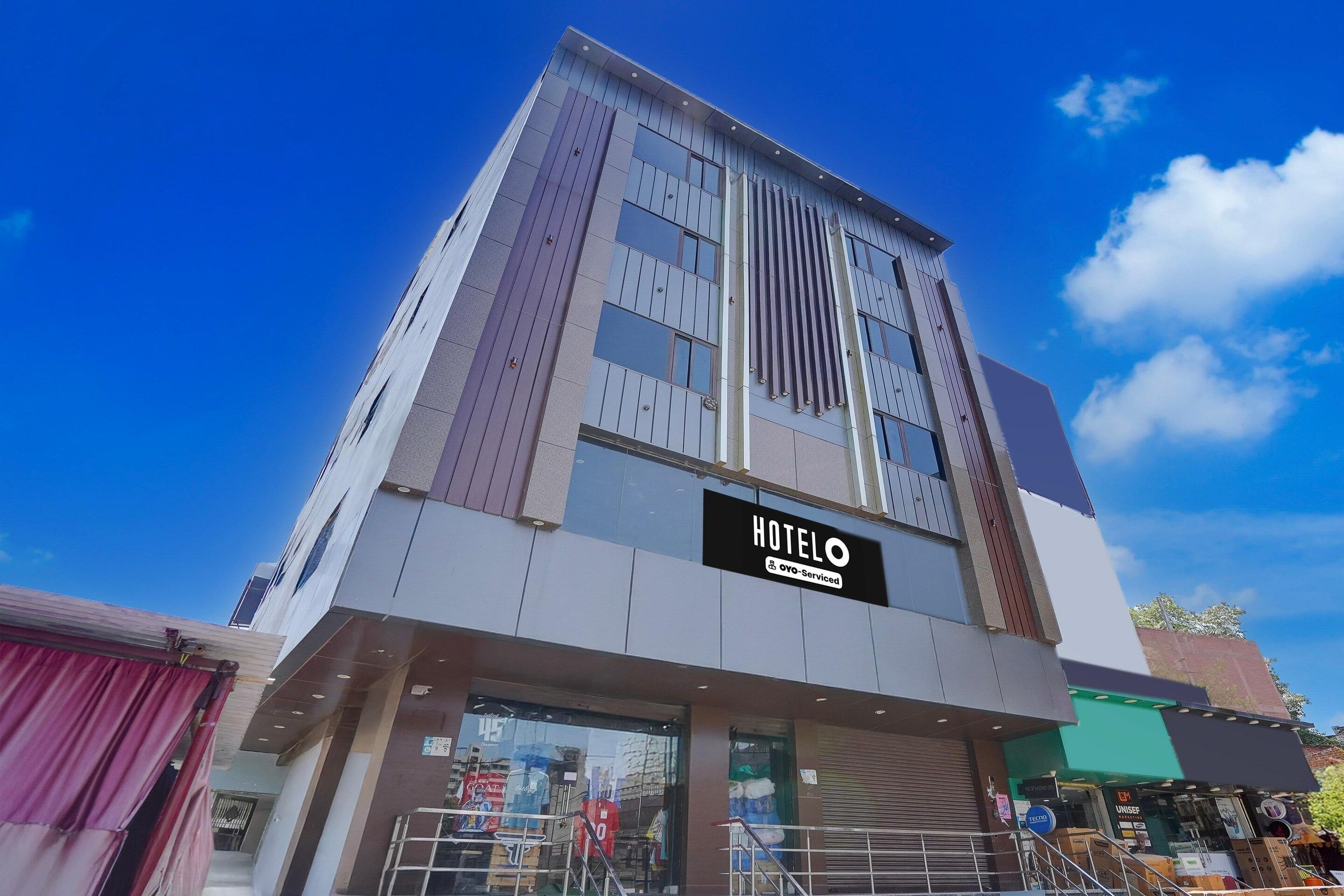 A modern hotel building with a prominent 'HOTEL' sign.