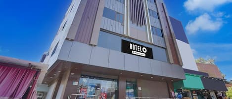 A modern hotel building with a prominent 'HOTEL' sign.