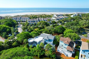 A coastal hotel with multiple buildings, a beach view, and lush greenery. - 1 Pelican- Easy Walk to Beach & Community Pool, Lagoon View! (Isle Of Palms)