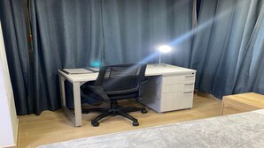 A room with a desk, chair, and a small cabinet. - Global Executive Suites 203 (Medellín)