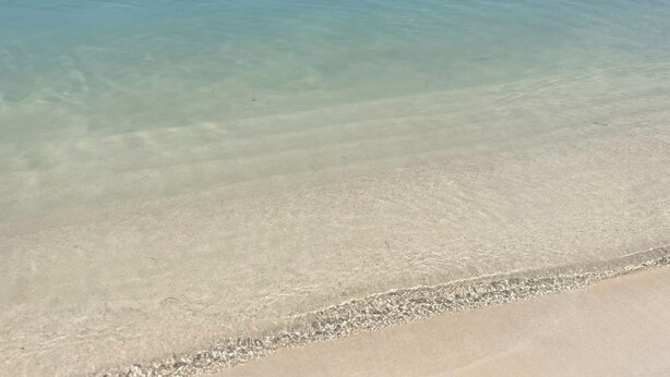 A beach with clear water and a distant landmass. - Your tropical escape in Playa Santa, Guanica. Beach days starts here. (Guánica)