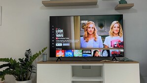 A flat-screen TV on a white entertainment center with a Netflix interface displaying 'LOOK BOTH WAYS' and 'Welcome to the Beach' sign above. - Your tropical escape in Playa Santa, Guanica. Beach days starts here. (Guánica)