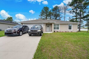 A two-story house with a garage, a driveway, and a well-maintained lawn. - Private 1-Bedroom with Private Entrance Ocala, FL (Ocala)