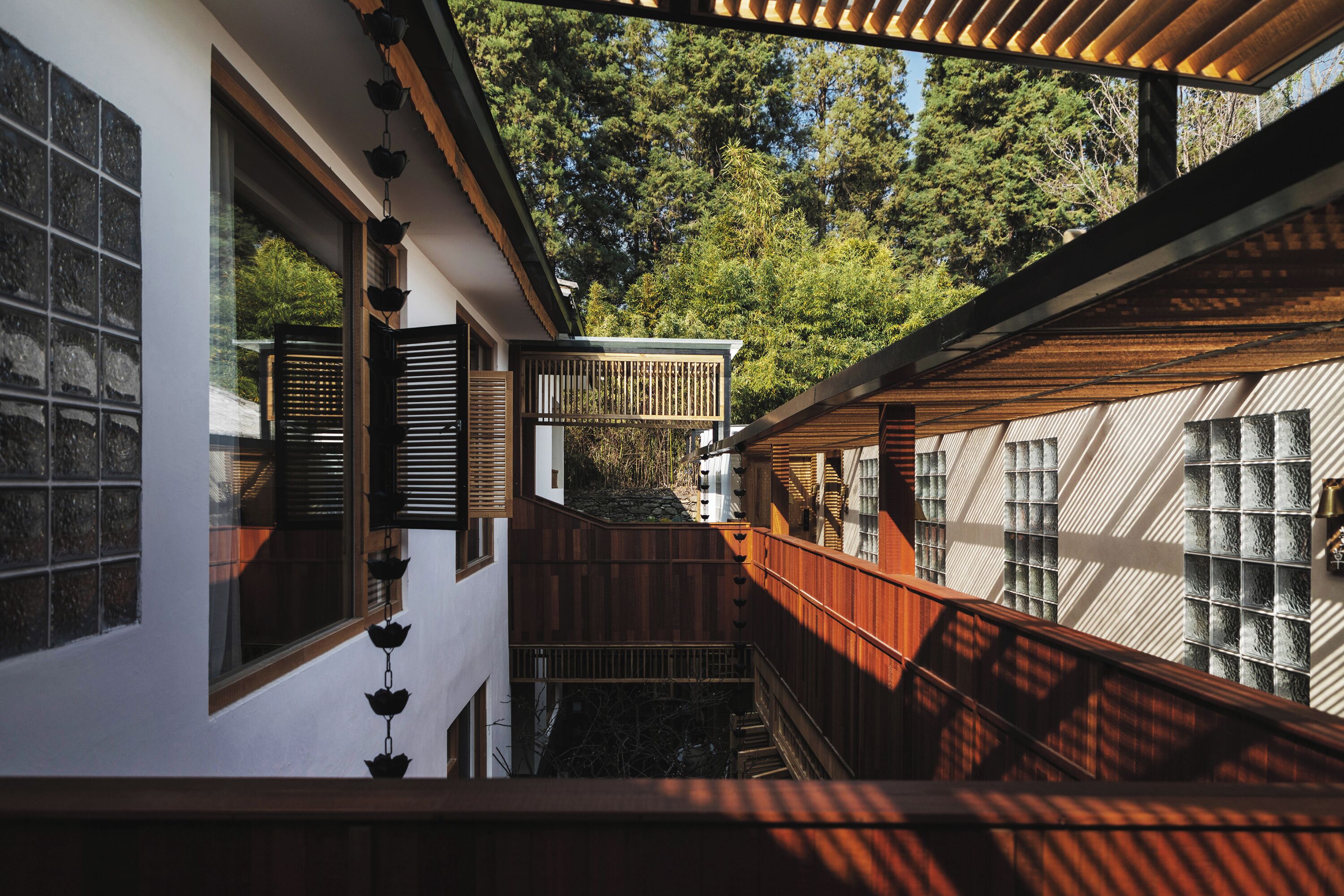 A multi-level wooden structure with a view of trees.
