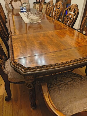 A wooden dining table with ornate chairs, a decorative bowl, and a patterned table runner. - Stunning Malibu 7 Bedroom Mansion/Castle with Swimming Pool (Malibu)