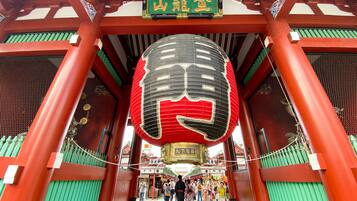 A traditional Japanese torii gate with a large lantern hanging above.