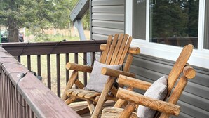 A wooden deck with Adirondack chairs and a window. - The Perch Point Studio- Peaceful getaway in Florrisant (Florissant)