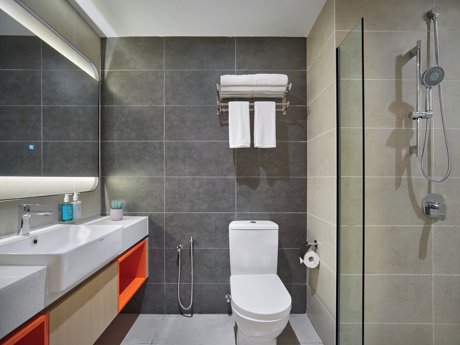 A modern bathroom with a toilet, bidet, and shower.