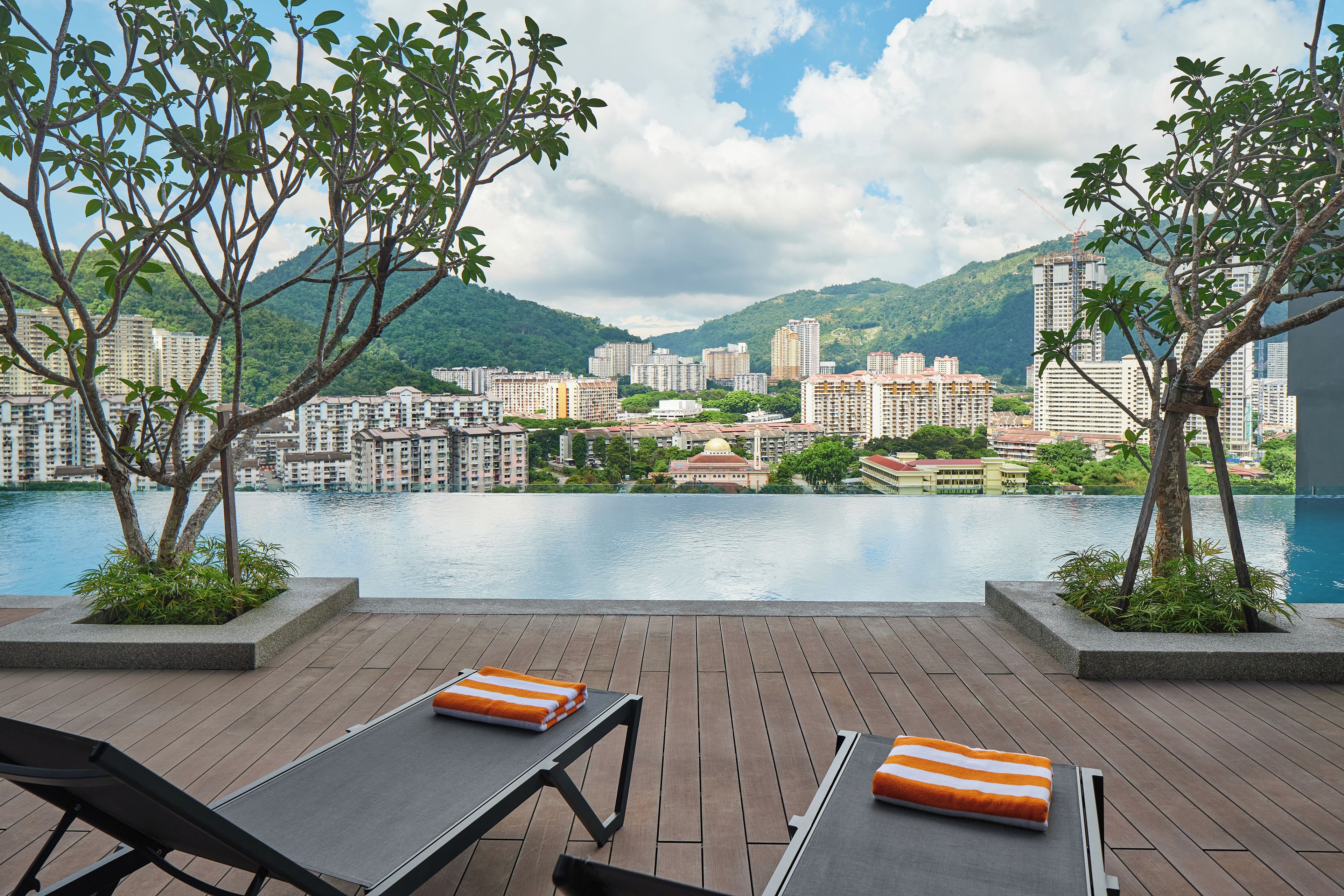 A terrace with a view of a cityscape and a body of water.