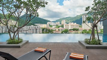 A terrace with a view of a cityscape and a body of water.