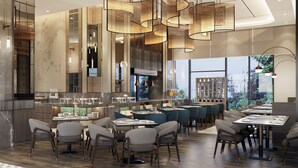 A modern restaurant with high ceilings, hanging pendant lights, and a bar area. - Oakwood Slipi Jakarta (Jakarta)