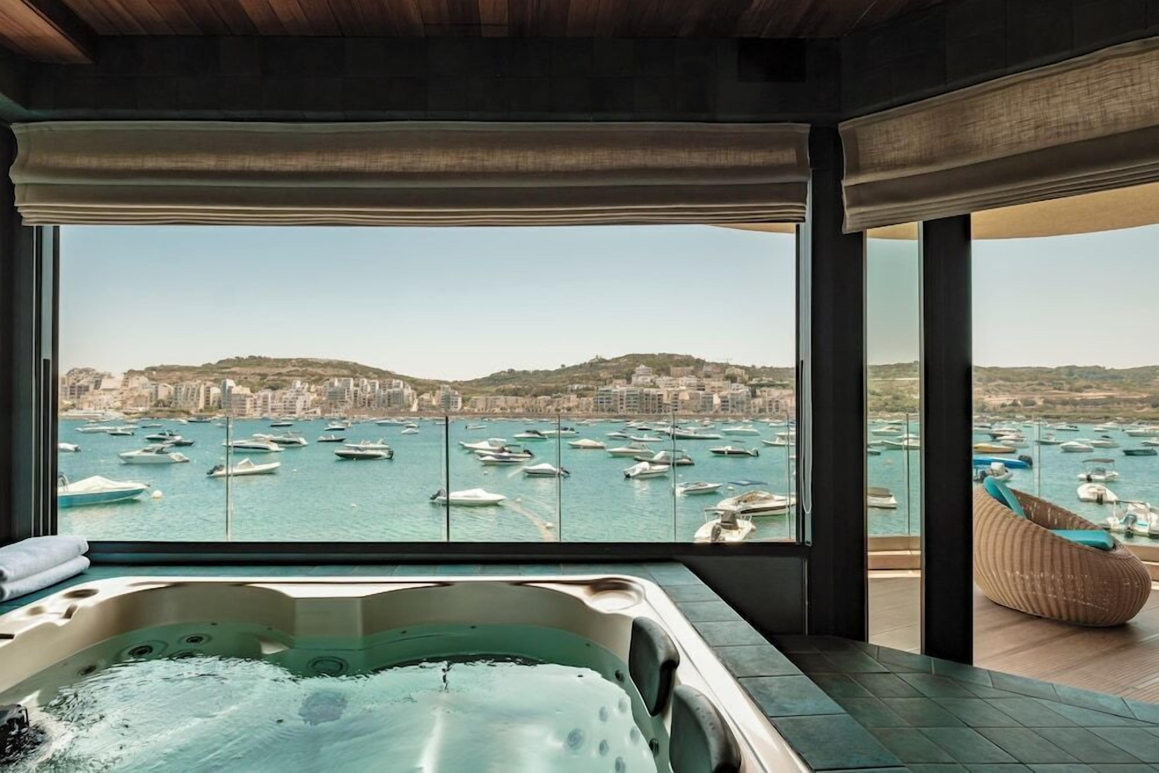 A hot tub with a city marina view.
