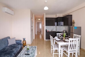 A modern living room with a sofa, coffee table, and a remote control. - Velaris Sea View Balcony 104, Vlore, Albania (Vlore)