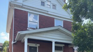 A two-story brick house with a front porch, a mailbox, and a door number 2231.
